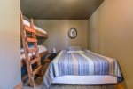 Lower bedroom with queen bed and built in twin bunks